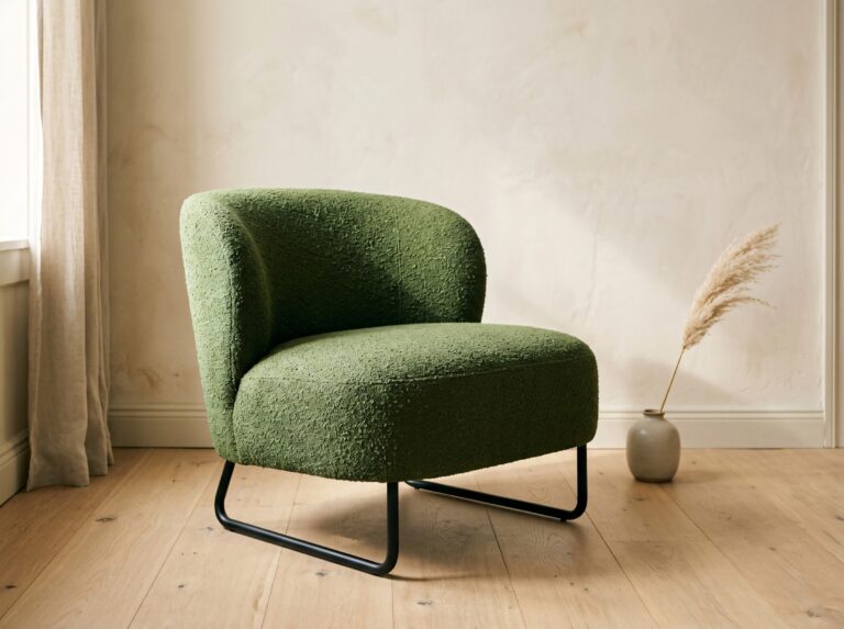 A moss bouclé sculptural lounge chair with a tubular steel base serves as a bold statement piece, a standout living room accent chair idea for anchoring a space.